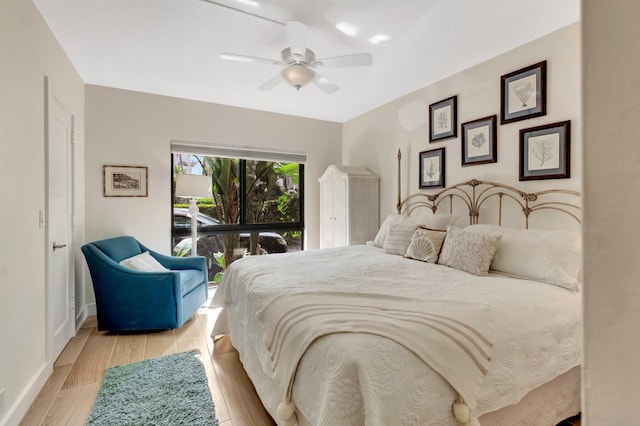 bedroom featuring ceiling fan, light hardwood / wood-style flooring, and access to exterior