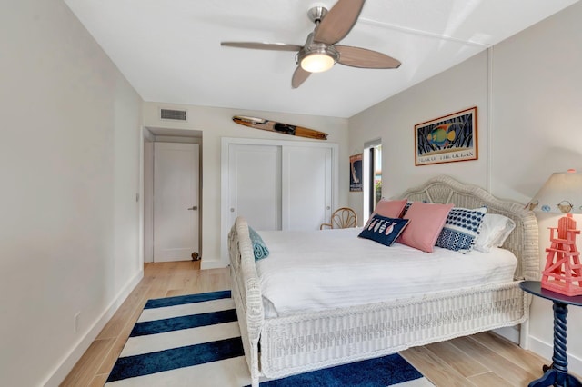 bedroom with a closet, ceiling fan, and light hardwood / wood-style flooring