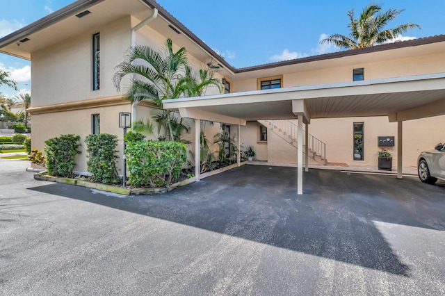 view of vehicle parking with a carport