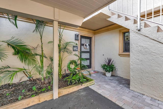 view of exterior entry featuring a patio area