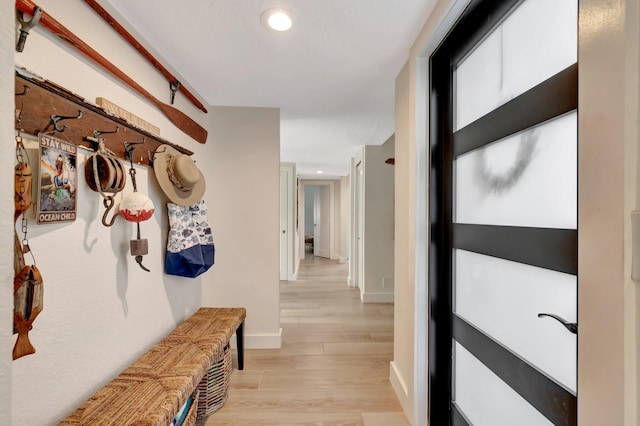 mudroom with light hardwood / wood-style floors