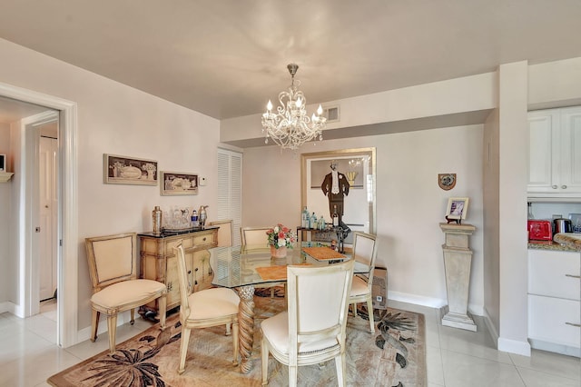 dining room featuring a notable chandelier and light tile patterned floors