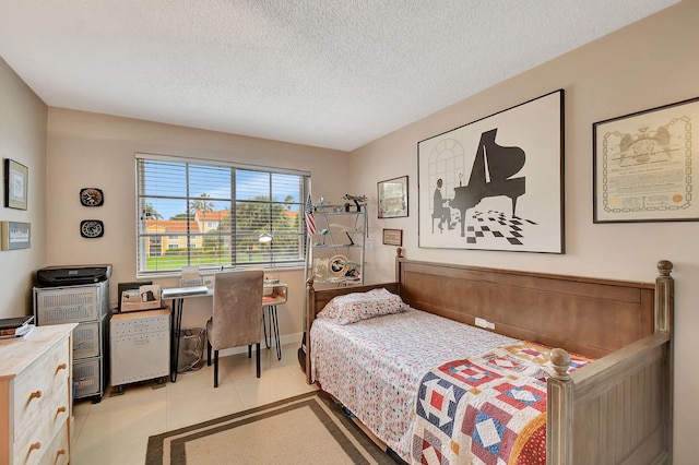 bedroom with a textured ceiling and light tile patterned floors