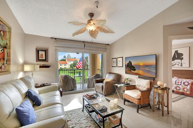 living room with lofted ceiling, a textured ceiling, light tile patterned floors, and ceiling fan