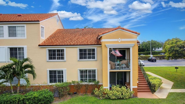 rear view of house with a yard