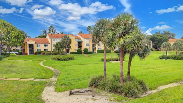 view of property's community with a lawn