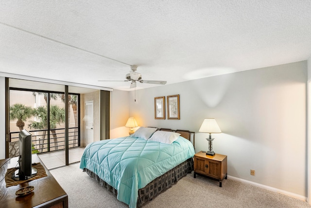 carpeted bedroom featuring ceiling fan, a textured ceiling, and access to exterior