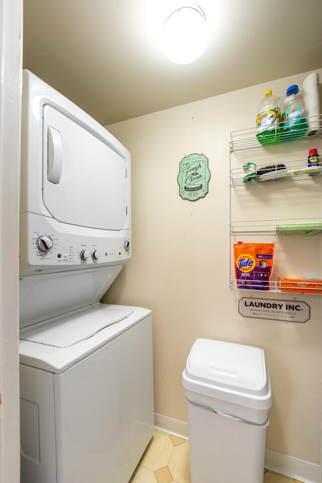 laundry room with stacked washer / drying machine