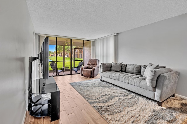 living room with hardwood / wood-style flooring, expansive windows, and a textured ceiling