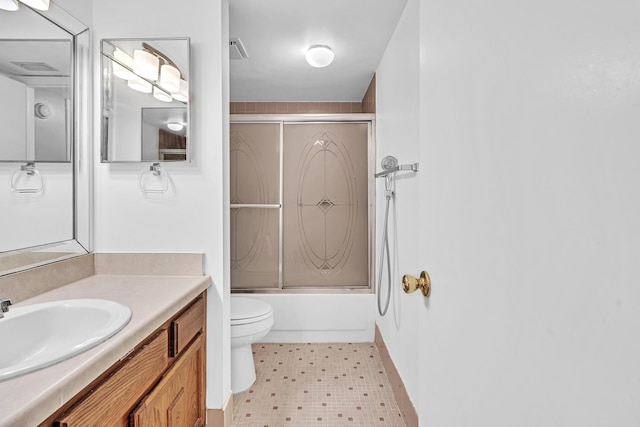 full bathroom featuring vanity, toilet, tile patterned flooring, and bath / shower combo with glass door