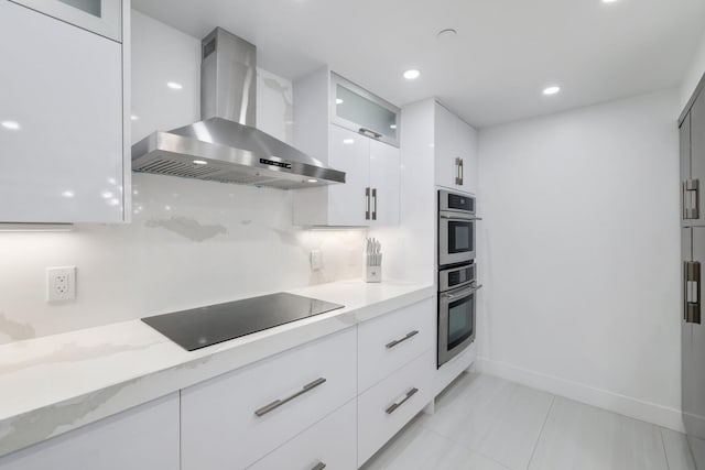 kitchen featuring black electric cooktop, white cabinetry, wall chimney exhaust hood, modern cabinets, and glass insert cabinets