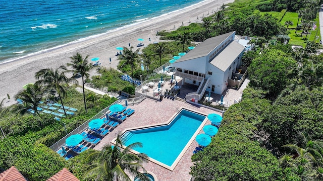 birds eye view of property with a beach view and a water view