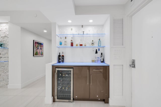 bar with light tile patterned floors, baseboards, wine cooler, a bar, and recessed lighting