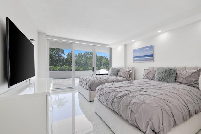 bedroom featuring access to outside, floor to ceiling windows, and recessed lighting