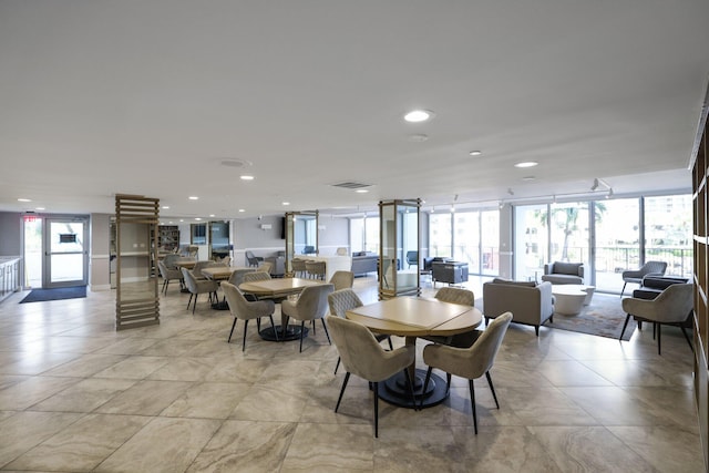 dining room featuring a wall of windows, recessed lighting, and visible vents