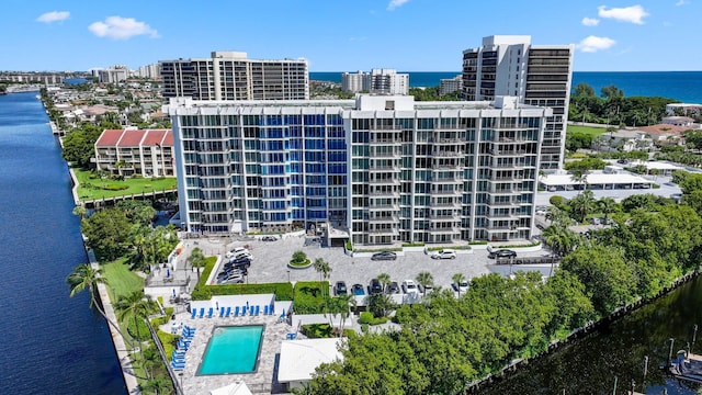 view of building exterior with a water view and a city view