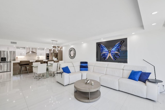 living room with a chandelier, visible vents, and recessed lighting