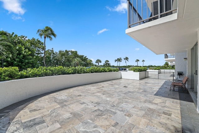 view of patio featuring a balcony