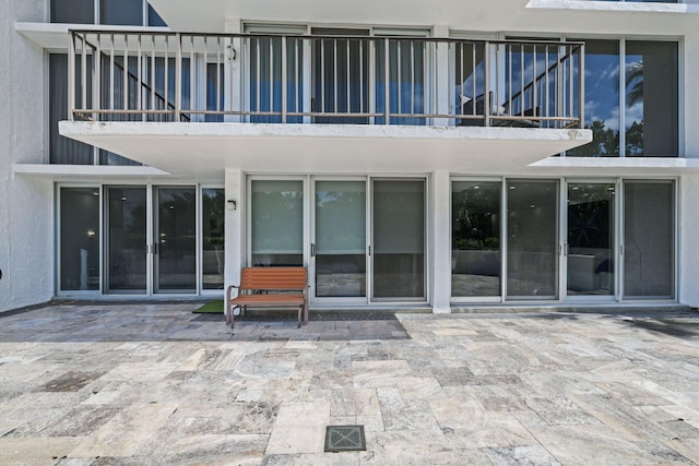 back of property featuring a patio area, visible vents, and stucco siding