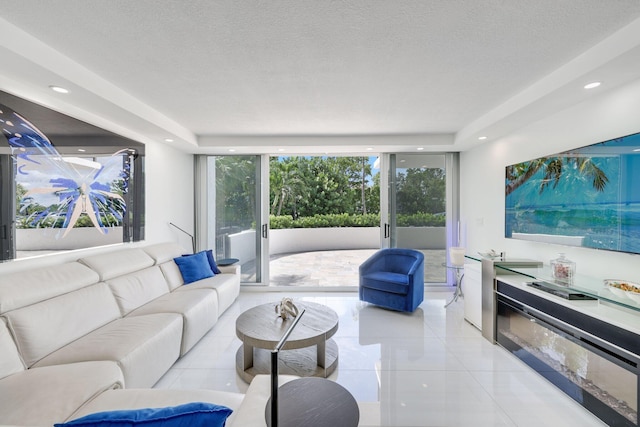 living area featuring expansive windows, light tile patterned floors, a textured ceiling, and recessed lighting