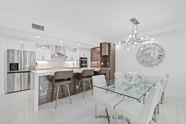 dining area featuring a notable chandelier, recessed lighting, visible vents, light tile patterned flooring, and baseboards