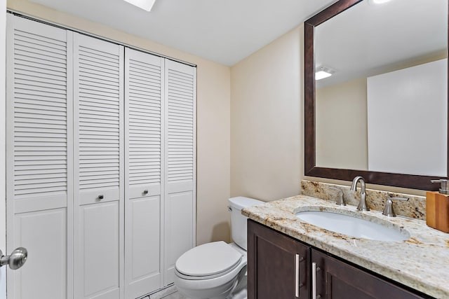 bathroom featuring toilet and vanity