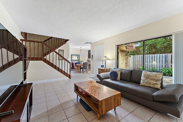 living room featuring light tile patterned flooring and a textured ceiling