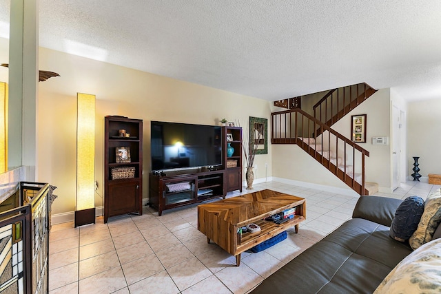 living room featuring a textured ceiling and light tile patterned flooring