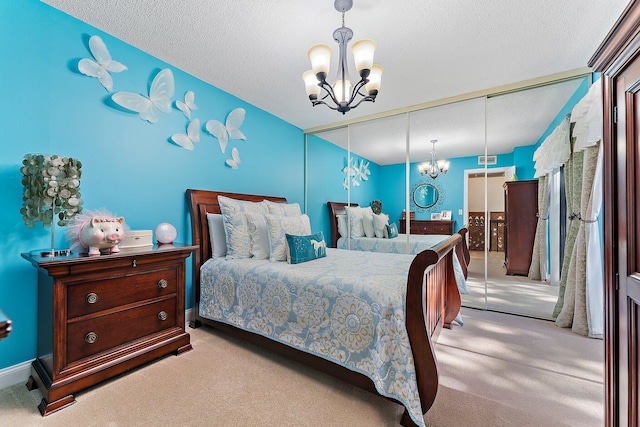 bedroom featuring a closet, a textured ceiling, and light colored carpet