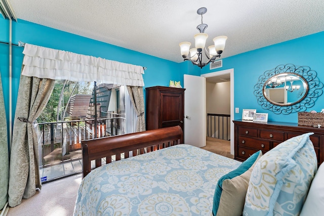 carpeted bedroom featuring a textured ceiling and an inviting chandelier