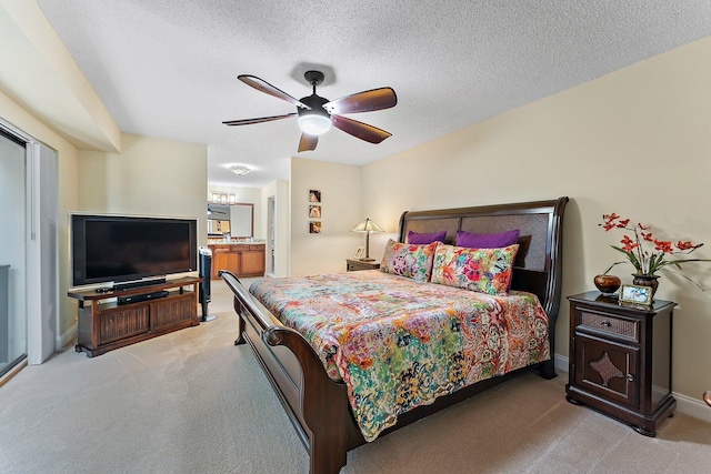 carpeted bedroom featuring a textured ceiling and ceiling fan