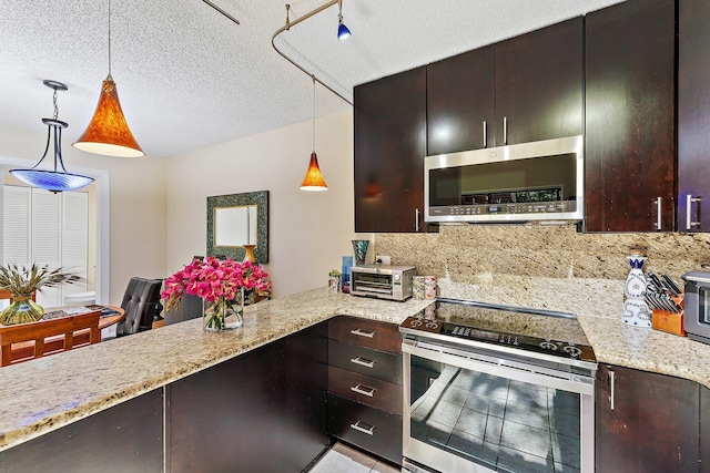 kitchen with a textured ceiling, decorative light fixtures, stainless steel appliances, and dark brown cabinets