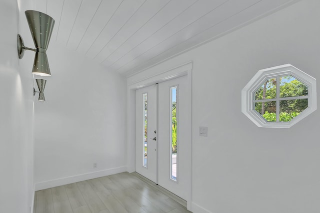 entryway featuring vaulted ceiling, wooden ceiling, and light hardwood / wood-style flooring