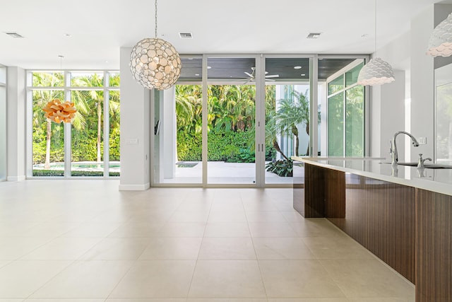 kitchen featuring plenty of natural light, sink, and floor to ceiling windows