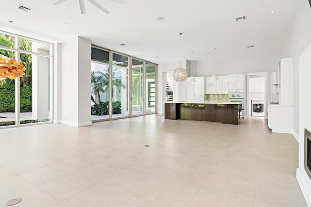 kitchen featuring white cabinets, a wealth of natural light, and a spacious island