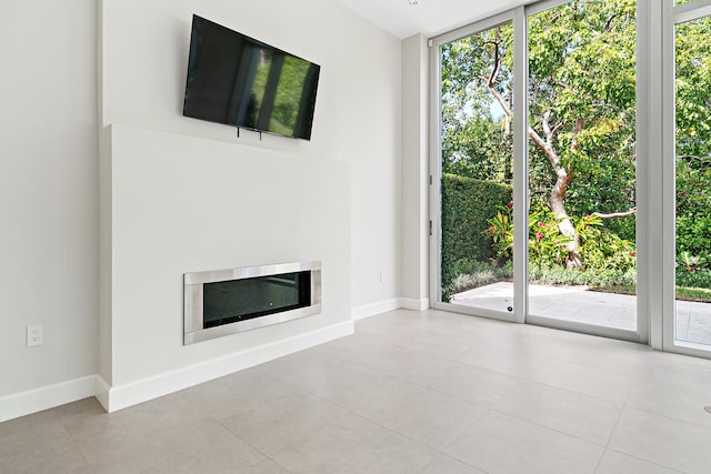 unfurnished living room featuring light tile patterned flooring and a healthy amount of sunlight