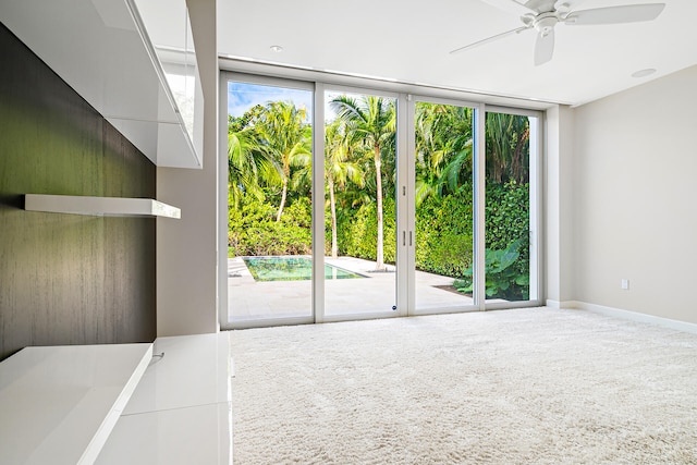 carpeted empty room with ceiling fan