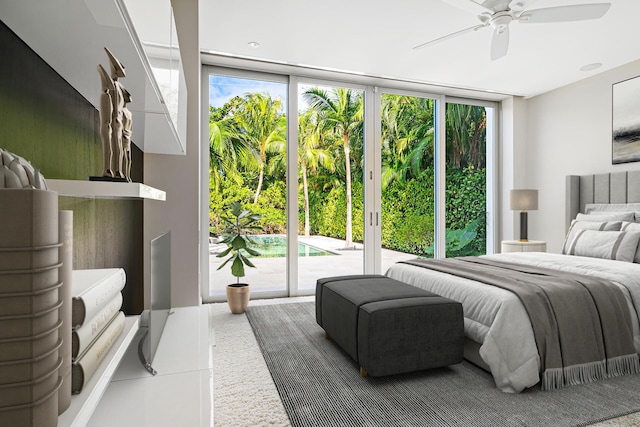 bedroom featuring a wall of windows, ceiling fan, and access to exterior