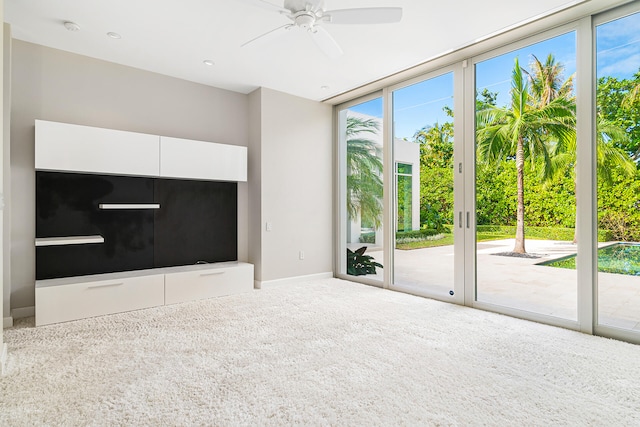 unfurnished living room with carpet flooring and ceiling fan