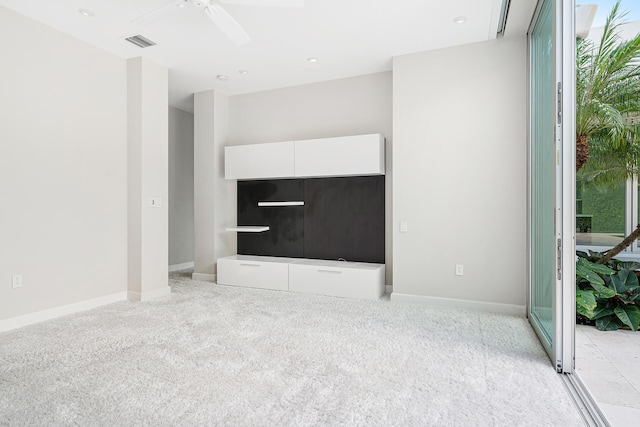 unfurnished living room featuring light carpet and ceiling fan