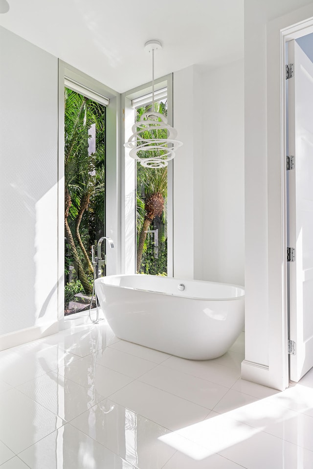 bathroom with tile patterned flooring and a bathing tub