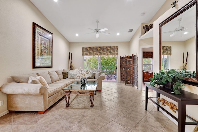 living room with ceiling fan, lofted ceiling, and light tile patterned floors