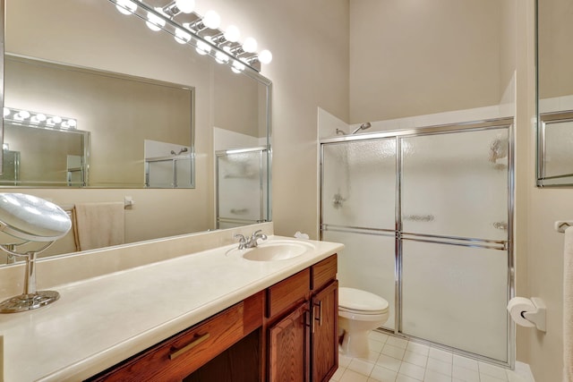 bathroom featuring vanity, tile patterned floors, toilet, and an enclosed shower