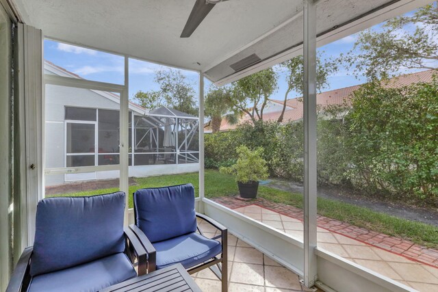 sunroom featuring ceiling fan