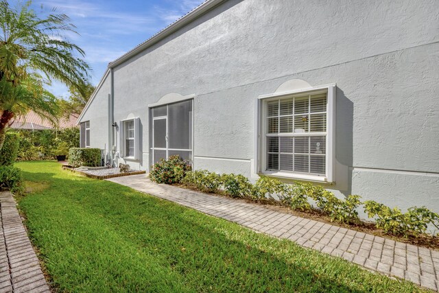 8503 Logia Cir, Boynton Beach, FL 33472 - view of property exterior featuring stucco siding and a lawn