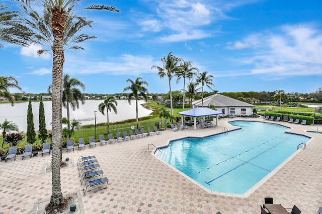 view of swimming pool featuring a water view, a gazebo, and a patio area