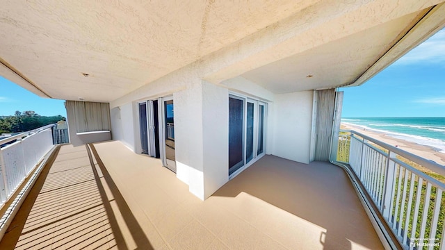 balcony with a view of the beach and a water view