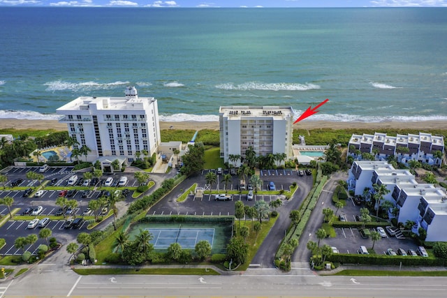 birds eye view of property featuring a water view and a view of the beach