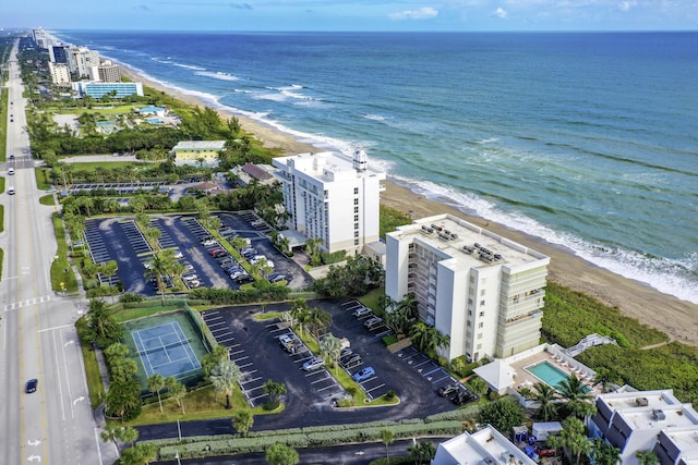 birds eye view of property featuring a water view and a beach view