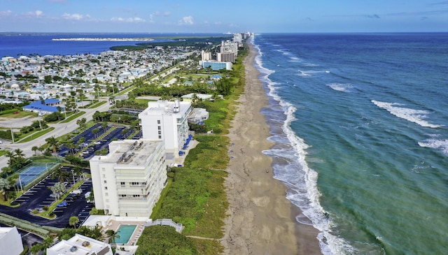 bird's eye view with a water view and a beach view